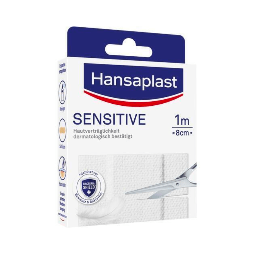 Csomagolás a Hansaplast Sensitive tapaszhoz - Különböző méretek a Beiersdorf AG-tól. A dobozon látható a márkalogó, a termék neve és egy olló képe, amely egy tapaszcsíkot vág. A csomagolás kiemeli a bőrgyógyászati jóváhagyást.