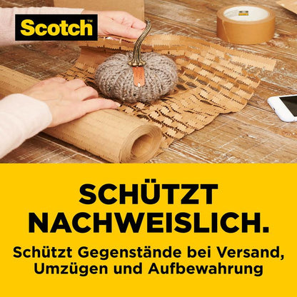 Egy kis dísztök biztonságosan be van csomagolva a Scotch™ Cushion Lock™ védőcsomagolásba (30,4 cm x 9,14 m) a 3M Deutschland GmbH-tól. Az asztalon ragasztószalag és buborékfólia található.