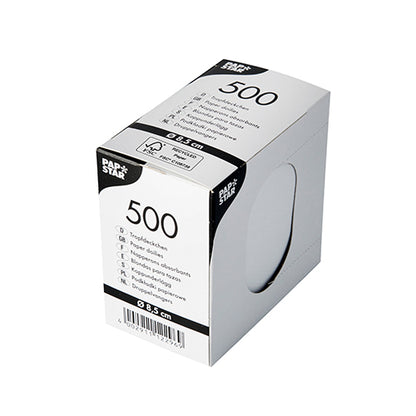 Egy fehér, téglalap alakú PAPSTAR-doboz 500 kerek cseppfogó alátéttel (Ø 8,5 cm) italalátétekhez termékinformációval, vonalkóddal és egy kerek kivágással (~5 cm) van ellátva, amely bepillantást enged a fehér szalvétákra.