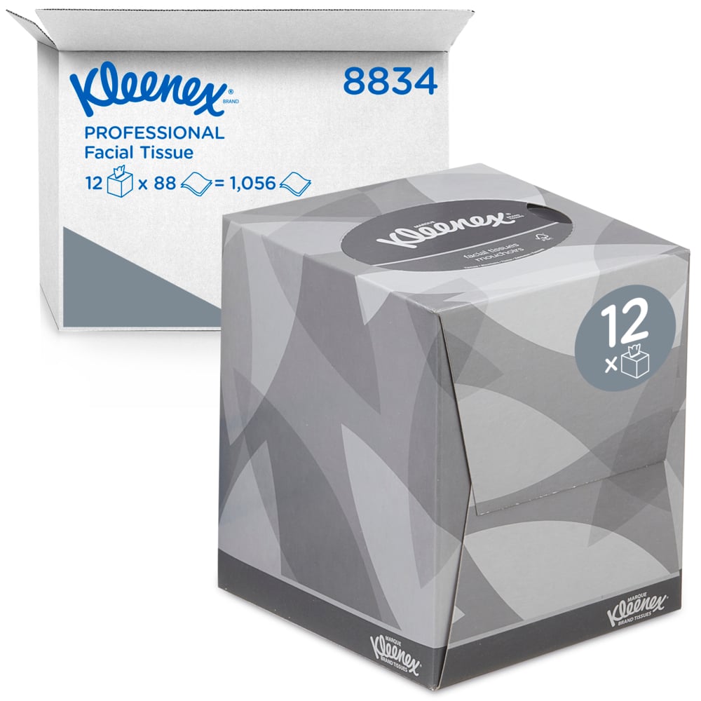 Eine Schachtel Kleenex® Kosmetiktücher - Würfel-Box / Weiß von Kimberly-Clark GmbH steht vor einer Kiste mit: 12 Boxen mit je 88 Tüchern, also insgesamt 1.056 Gesichtspflege-Tücher.
