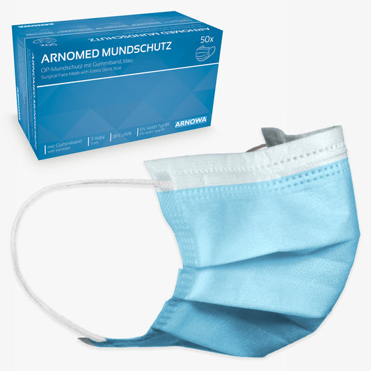 Hinter einer einzelnen hellblauen Einwegmaske mit weißen elastischen Ohrschlaufen steht eine blaue Schachtel mit der Aufschrift "ARNOMED MUNDSCHUTZ TYP IIR OP-Mundschutz mit Gummibändern Typ IIR" der ARNOWA GmbH, mit einer Maskenabbildung und deutschem Text.