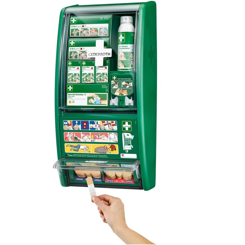 Az Orkla Wound Care AB Cederroth elsősegély-állomása egy zöld, falra szerelhető elsősegély-doboz feliratozott rekeszekkel és illusztrált képekkel. Egy kéz látható, amint egy sebtapaszt húz ki az alsó rekeszből. (1 csomag/doboz).