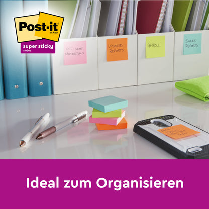 Eine Reihe von Aktenordnern mit bunten Post-it® Super Sticky 100% Recycling Notes (47,6 x 47,6 mm, 70 Blatt/Block, PEFC), Stiften und einem Telefon auf einem Schreibtisch. Die Haftnotizen beschriften Dokumente. Text: "Ideal zum Organisieren." Abgebildetes 3M-Logo.