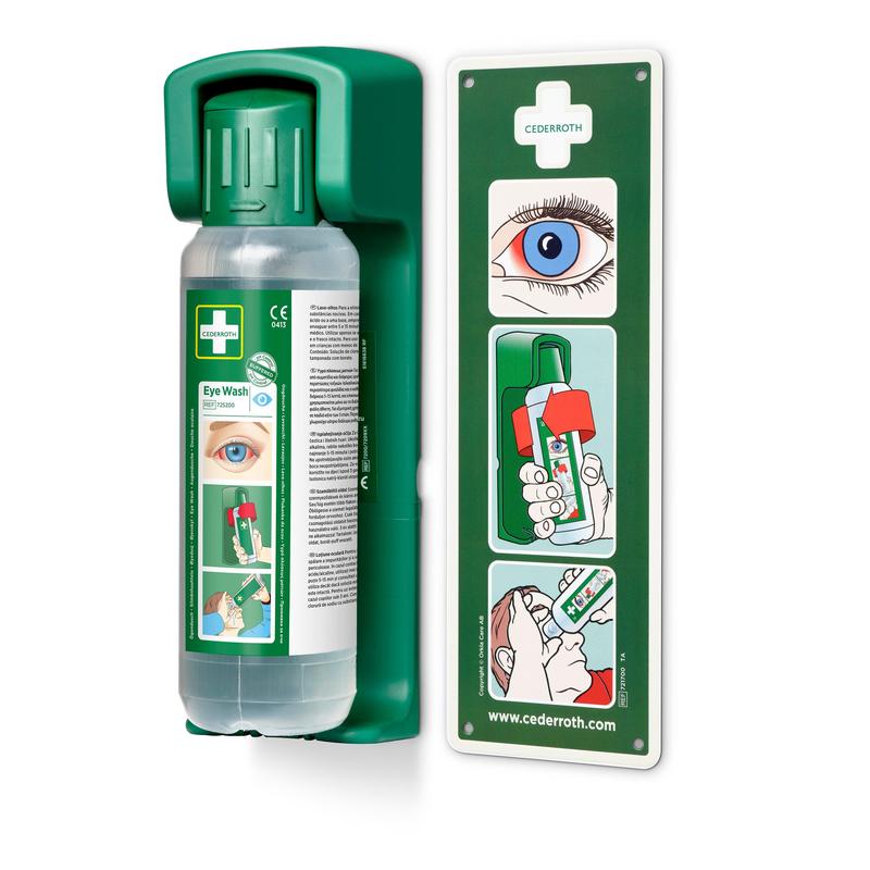 A képen látható egy falra szerelhető Orkla Wound Care AB tartó 500 ml-es szemöblítéshez, egy foszforeszkáló figyelmeztető táblával és egy áttekinthető útmutató diagrammal a szemöblítés lépésről lépésre történő útmutatásához.
