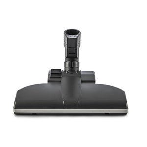 A TASKI Aero UP Standard fúvóka a Diversey Deutschland GmbH & Co. OHG-tól egy fekete padlófeltét téglalap alakú alappal és központi csatlakozóval, tökéletes kereskedelmi területekre. Illeszkedik a TASKI Aero UP-hoz, csomagolás (1 darab), elölnézetben ábrázolva fehér háttér előtt.