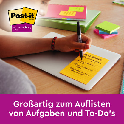 Egy kéz ír egy sárga Post-it® Super Sticky Meeting Note-ra (203 x 153 mm, 70 lap, 100% PEFC, különböző színek, 3 blokk/csomag a 3M Deutschland GmbH-tól) - ideális feladatok jegyzetelésére.