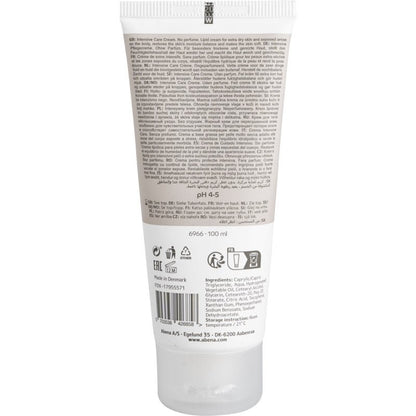 Egy 100 ml-es Abena Re-Seller GmbH zsíros krém tubus hátulnézete száraz bőrre, karton (12 csomag), termékinformációval, használati utasítással, összetevők listájával, vonalkóddal és gyártói adatokkal több nyelven.