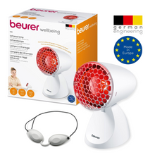 Eine Beurer Infrarotlampe IL 11 (Auslaufartikel) der Beurer GmbH wird mit ihrer Verpackung gezeigt. Die Verpackung hebt die deutsche Technik, das Branding des Produkts und die Tatsache, dass es in Europa hergestellt wird, hervor.