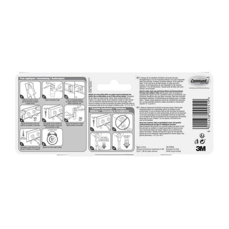 A Command™ kulcstartó sín hátoldala kvarc színben, HOM18-Q a 3M Deutschland GmbH-tól képes lépésről-lépésre szerelési útmutatóval, többnyelvű utasításokkal, vonalkóddal, újrahasznosítási szimbólumokkal és 3M védjeggyel fehér háttérrel.